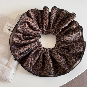 Detail of oversized leopard print velvet scrunchie with Blind For Love woven label