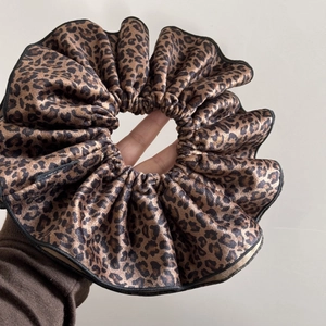 Detail of large leopard print velvet scrunchie with soft ruffled edge craftsmanship