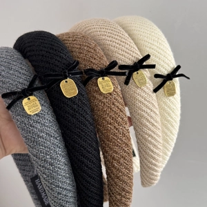 Knitted headbands with velvet bows and gold plates in multiple neutral colors