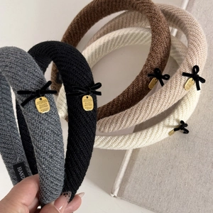 Detailed macro view of knitted texture on headbands with small black velvet bows
