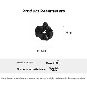 Detail showing oversized dark gray textured fabric scrunchie with 14cm diameter dimensions