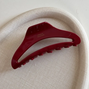 Detail of burgundy acetate hair claw showing the gold France Handmade brand logo inside