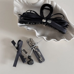 Gray fabric bow hair claw set with silver heart charms and rhinestone details