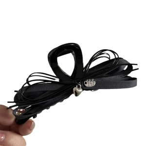 Elegant grey fabric bow hair claw clip featuring a silver heart pendant and metal charm