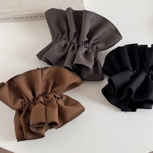 Solid color pleated fabric hair ties in brown, dark grey and black on white background