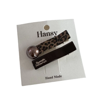 Leopard print and black hair clip set with pearl accents and gold lettering detail