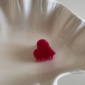 Detail of handmade magenta acetate hair claw clip with France engraved lettering