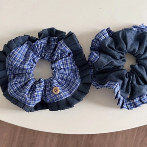 Close-up of blue plaid scrunchie set featuring vintage wooden buttons and pleated fabric edges