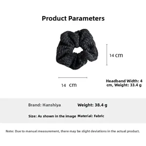 Detail view of 14cm black knitted scrunchie showing fabric texture and dimensions