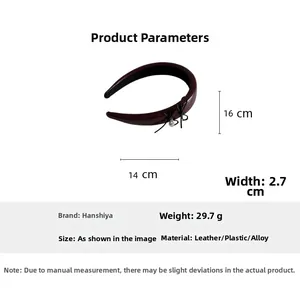 Close-up of burgundy leather headband with small bow detail and sizing specifications