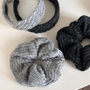 Detailed view of grey and black knitted headbands and scrunchies with wool textures