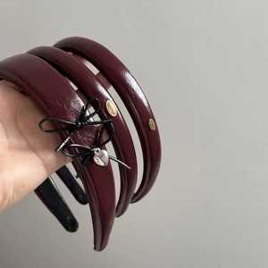 Burgundy faux leather headbands with bow and heart pendant for a vintage women look