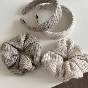 Detailed view of the knit hair accessories set featuring chunky wool texture and soft patterns