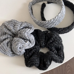 Detailed view of knitted wool scrunchies and headbands in black and grey for winter
