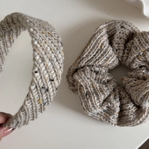 Detail view of beige knitted headband and scrunchie set with multicolored fiber spots