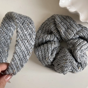 Detailed macro view of grey cable-knit headband and scrunchie with wool blend texture