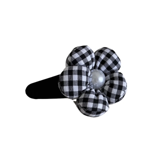 Vintage black and white checkered flower hair clip with pearl center on white background