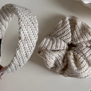 Detail view of cream-colored knit scrunchie and headband set with ribbed texture