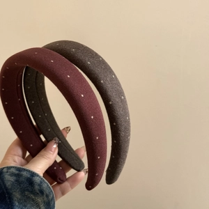 Detail showing padded polka dot headbands in burgundy and grey with fabric texture