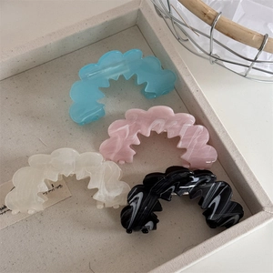 French minimalist wavy hair claw clips in pastel and marble patterns for elegant styling