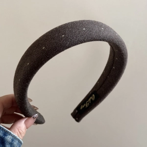 Detail of vintage brown polka dot headband with thick padding and inner brand label