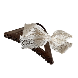 Elegant lace bow claw clip for women featuring brown acrylic material in a retro style