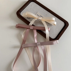 Three-piece satin ribbon bow hair clips in cream, pink and mauve for elegant hair styling