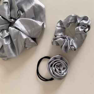 Three-piece set of elegant silver-grey satin hair scrunchies with handmade rose flower detail