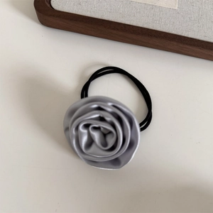 Detailed view of handmade silver grey satin rose hair scrunchie with elegant silk texture