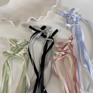 Detailansicht bunter Satin-Schleifen-Haarspangen mit langen Bändern in Pastelltönen