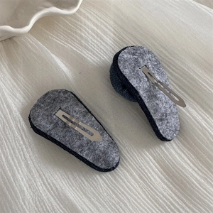 Detailed back view of denim rose hair clips with gray felt pads and silver metal BB clips