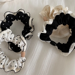 Polka dot and lace trim scrunchies set with decorative beads on textured fabric