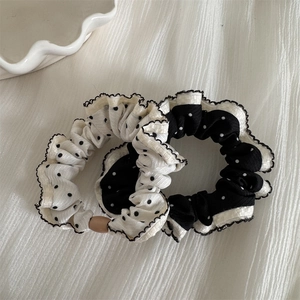 Black and white polka dot hair scrunchies with ruffle edges and wood bead detail