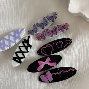 Detailed set of 7 sweet hair clips featuring pink and purple bow and heart patterns
