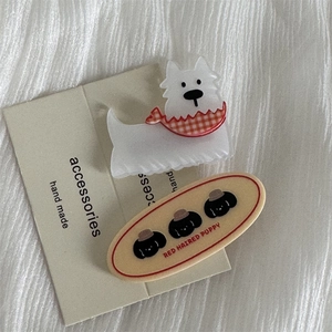 Detail of cute dog-themed hair clip set with white puppy claw and beige snap clip