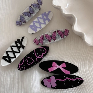 Detailed set of elegant oval hair clips with purple butterfly and bow patterns