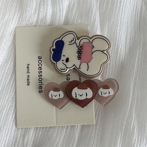 Detail showing cute acrylic dog hair clips and heart shapes on handmade backing card
