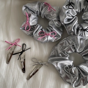 Detail view of silver Y2K hair scrunchies and BB clips set with colorful ribbon bows