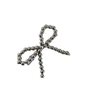 Modern silver beaded bow hair clip with a sleek metallic finish and alligator grip