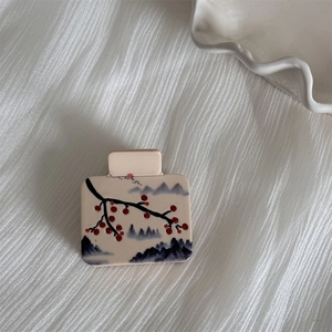 Detailed close-up of square acetate hair claw with ink wash plum blossom design