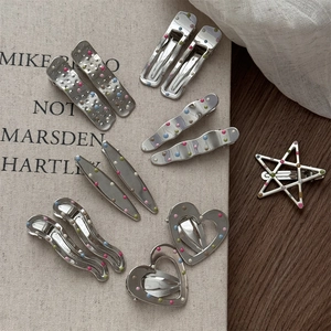 Silver metal hair clips set with colorful dots and various shapes like stars and hearts