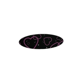 Sweet pink and black oval hair clip featuring purple heart patterns and white stars