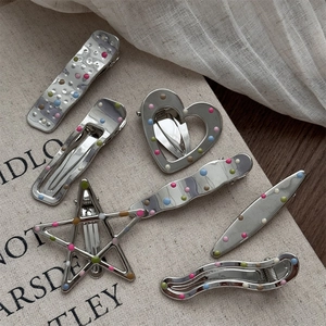 Polka dot oil drop silver metal hair clip set with heart and star shapes on canvas