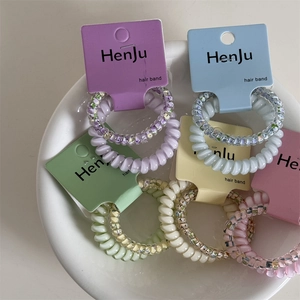 Set of floral and solid colorful spiral hair ties in soft pastel tones for women