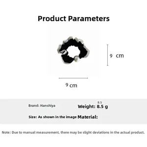 Detail view showing 9cm diameter and 8.5g weight of black lace scrunchie with white pearl