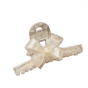 Elegant French acetate bow hair claw clip in creamy pearlescent white with brand logo