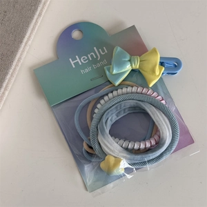 Close-up of sweet dopamine hair accessory set including bow clip and elastic hair ties