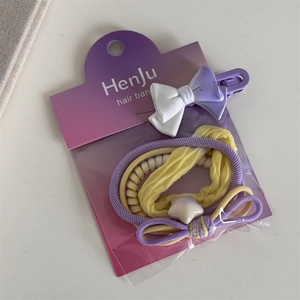 Detail of sweet purple and yellow hair accessory set with bow clip and elastic bands