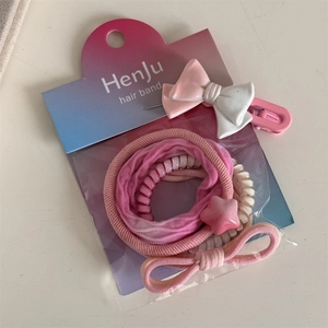 Detail of pink sweet hair accessories set with bow clip and spiral elastic bands