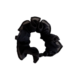 Minimalist black ruffle scrunchie hair tie with layered translucent mesh edges on white